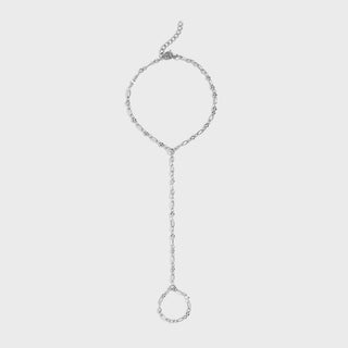 Silver hand chain on a light gray background