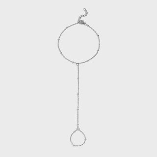 Silver hand chain  on a light gray background