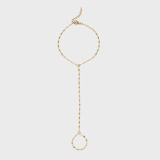 Gold hand chain on a light gray background