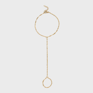 Gold hand chain with a singapore design on a light gray background