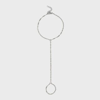Silver hand chain on a light gray background
