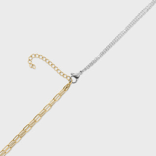Gold and silver chain necklaces on a light gray background