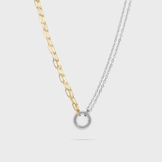 Two necklaces, one gold and one silver, on a light gray background
