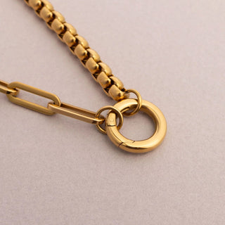 Gold chain with a clasp on a beige background