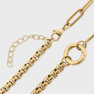 Gold chain bracelet on a light gray background