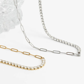 Two necklaces, one gold and one silver, on a white background