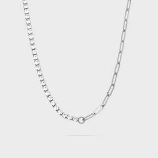 Silver chain necklace on a light gray background