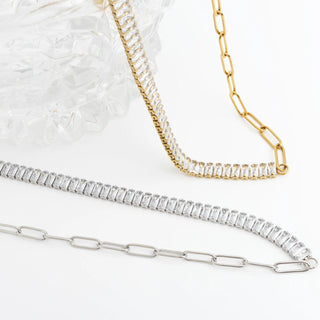 Two diamond necklaces, one gold and one silver, on a white background.