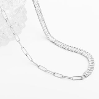 Silver chain necklace with clear gemstones on a white background