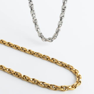 Gold and silver chain necklaces on a white background