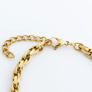 Gold chain bracelet on a white background