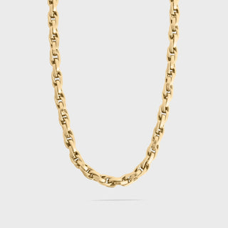 Gold chain necklace on a light gray background