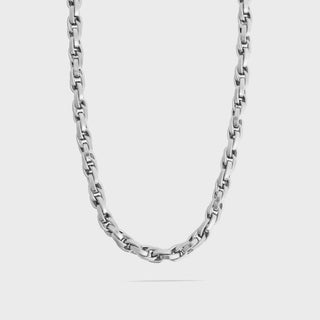 Silver chain necklace on a light gray background