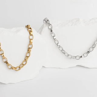 Gold and silver chain necklaces on a white background