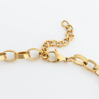 Gold chain bracelet on a white background