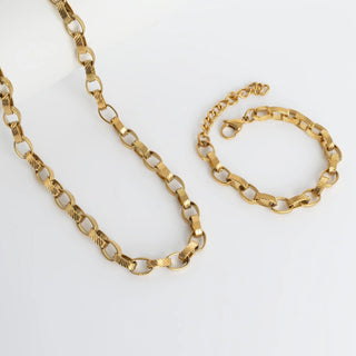 Gold chain necklace and bracelet on a white background