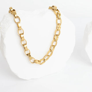Gold chain bracelet on a white background