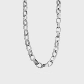 Silver chain necklace on a light gray background