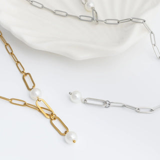 Gold and silver y-shaped chain necklaces with two pearls on a white background
