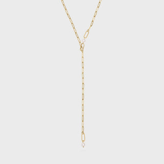 Gold y-shaped chain necklace on a light gray background