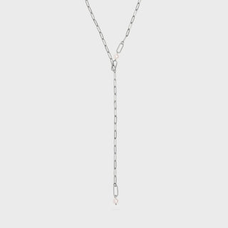 Silver chain necklace on a light gray background