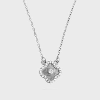Silver necklace with a floral pendant on a light gray background