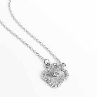 Silver necklace with a floral pendant on a white background
