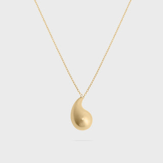 Gold tear drop-shaped pendant on a white background