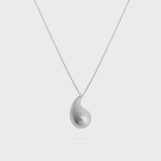 Silver teardrop pendant necklace on a light gray background