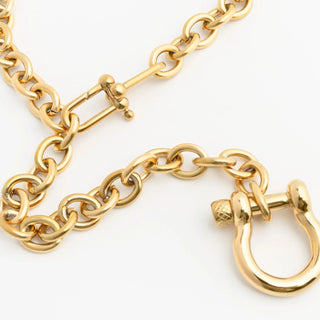 Gold chain with carabiner on a white background