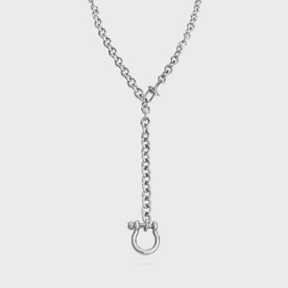 Silver necklace with a unique clasp on a light gray background