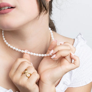 Person wearing a pearl necklace