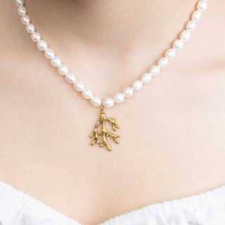 Pearl necklace with a gold coral pendant