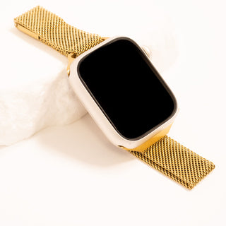 Smartwatch with a gold mesh band on a white background