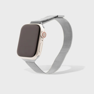 Smartwatch with a metal mesh band on a light gray background