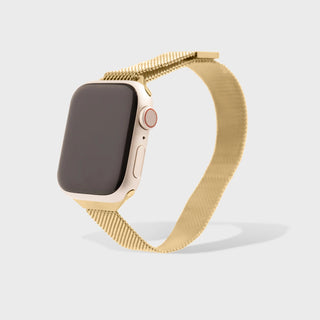 Gold smartwatch with mesh band on a light gray background