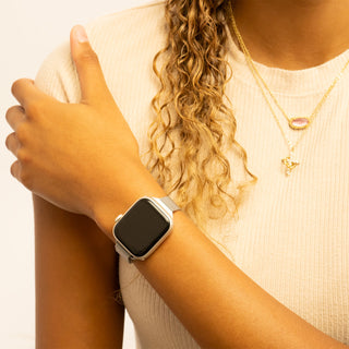 Person wearing a smartwatch with a plain background