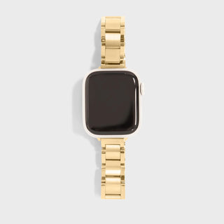 Smartwatch with a gold metal band on a light gray background