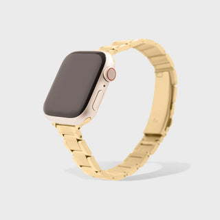 Smartwatch with a gold metal band on a light gray background