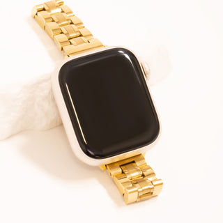 Smartwatch with a gold metal band on a white background