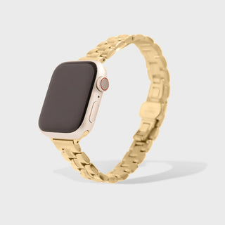 Smartwatch with a gold metal band on a light gray background