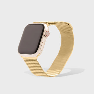Smartwatch with a gold mesh band on a light gray background