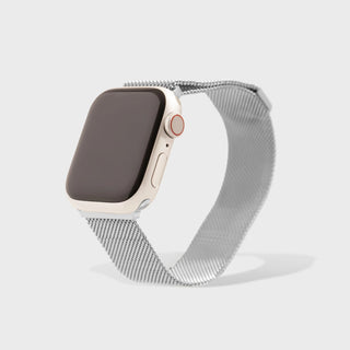 Smartwatch with a silver mesh band on a light gray background