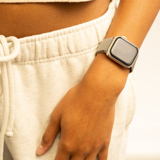Person wearing a smartwatch on a light background
