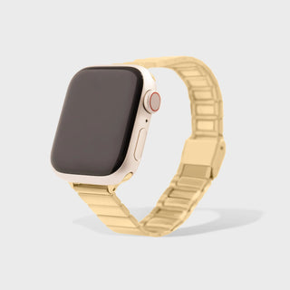 Smartwatch with a gold metal band on a light gray background