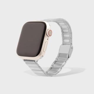 Smartwatch with a silver metal band on a light gray background