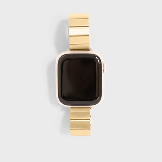 Smartwatch with a gold metal band on a light gray background