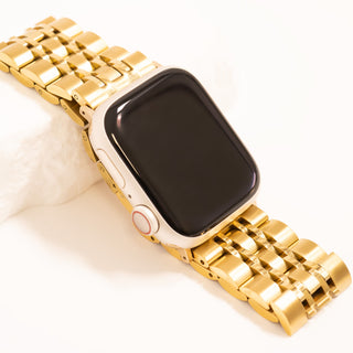 Smartwatch with a gold metal band on a white background