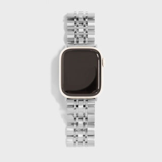 Smartwatch with a silver metal band on a light gray background