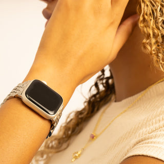 Person wearing a smartwatch with a close-up on the wrist and hand.